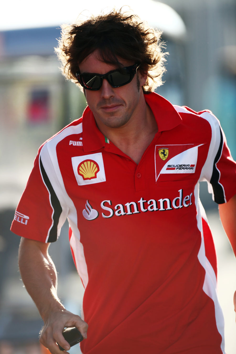 Fernando Alonso jogs through the paddock