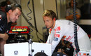 Jenson Button analyses data during first practice