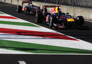 Sebastian Vettel leads Lewis Hamilton in to the pit lane