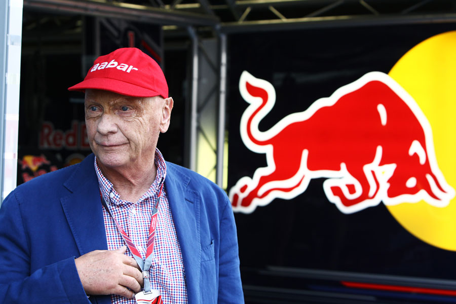 Niki Lauda sports a new Aabar sponsored version of his red cap