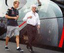 Sebastian Vettel and Bernie Ecclestone in the paddock on Sunday morning