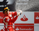 Fernando Alonso celebrates on top of the podium