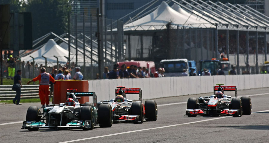 Michael Schumacher leads Lewis Hamilton and Jenson Button into the first chicane