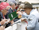 Sir Stirling Moss signs autographs for fans