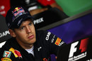 A stern-faced Sebastian Vettel in the driver press conference