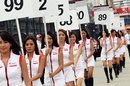 Grid girls march through the paddock
