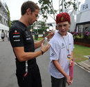 Jenson Button signs a fans shirt on Saturday