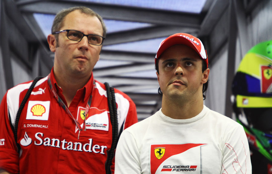 Felipe Massa and Stefano Domenicali looking unimpressed in the Ferrari garage
