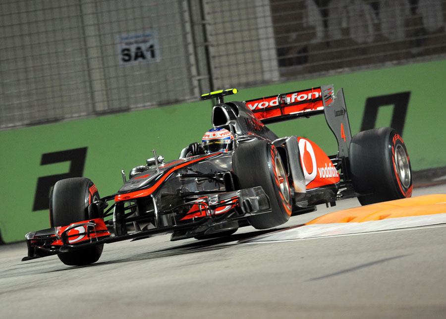 Jenson Button skips over the kerbs at turn 10