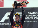 Sebastian Vettel raises his trophy on the podium