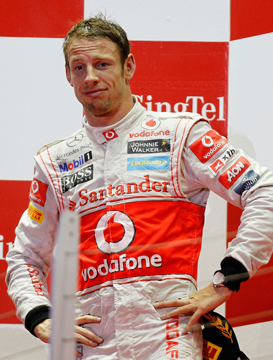Jenson Button cuts a drained figure on the podium