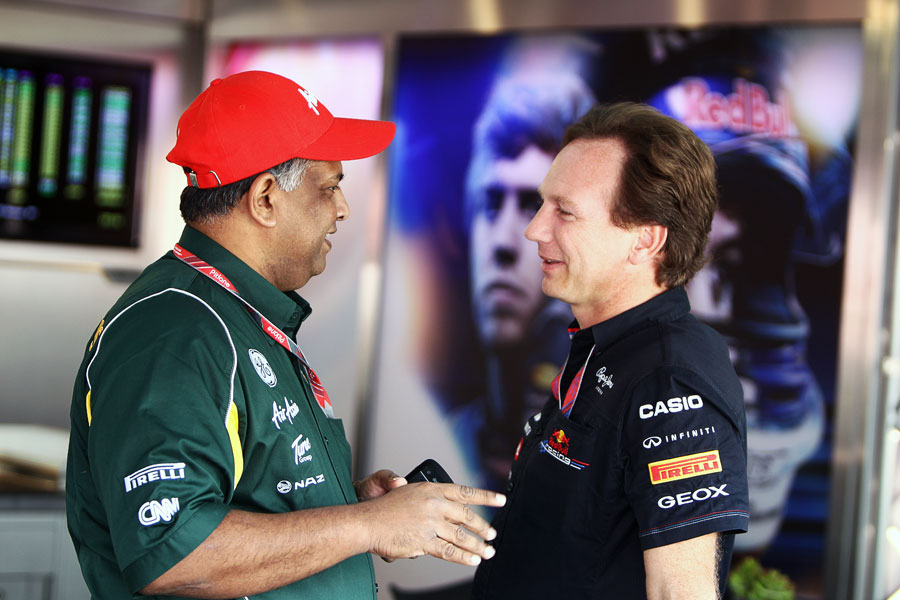 Tony Fernandes talks to Christian Horner in the Red Bull garage