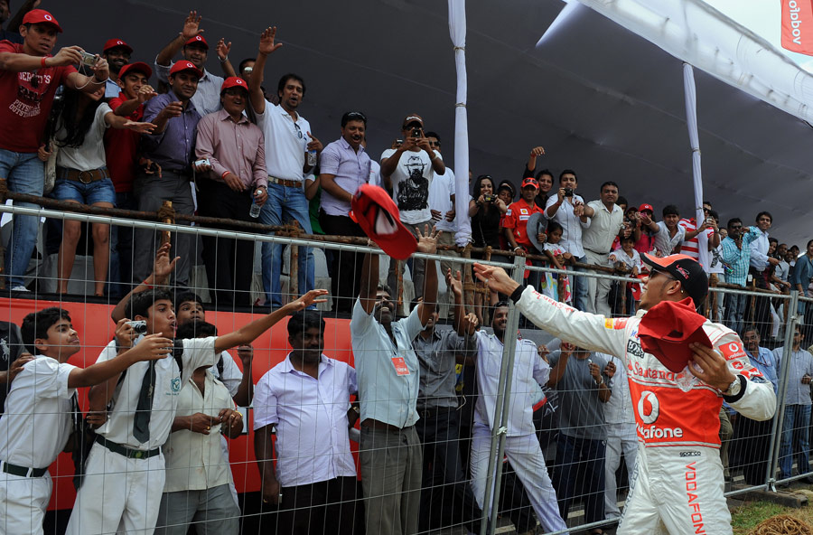 Lewis Hamilton throws McLaren goodies to fans in Bangalore