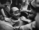 Juan Manuel Fangio returns to the paddock after victory