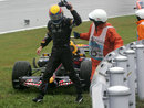 A furious Mark Webber heads for safety after a collision with Sebastian Vettel put him out of the race