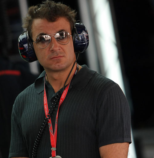 Jean Alesi watches practice from the Toro Rosso garage