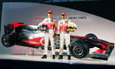 Jenson Button and Lewis Hamilton stand in front of their new car