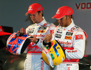 Jenson Button and Lewis Hamilton show off their helmet designs