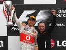 Jenson Button celebrates on the podium with McLaren technical director Paddy Lowe