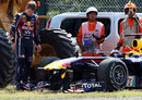 Sebastian Vettel assesses the damage to his Red Bull 