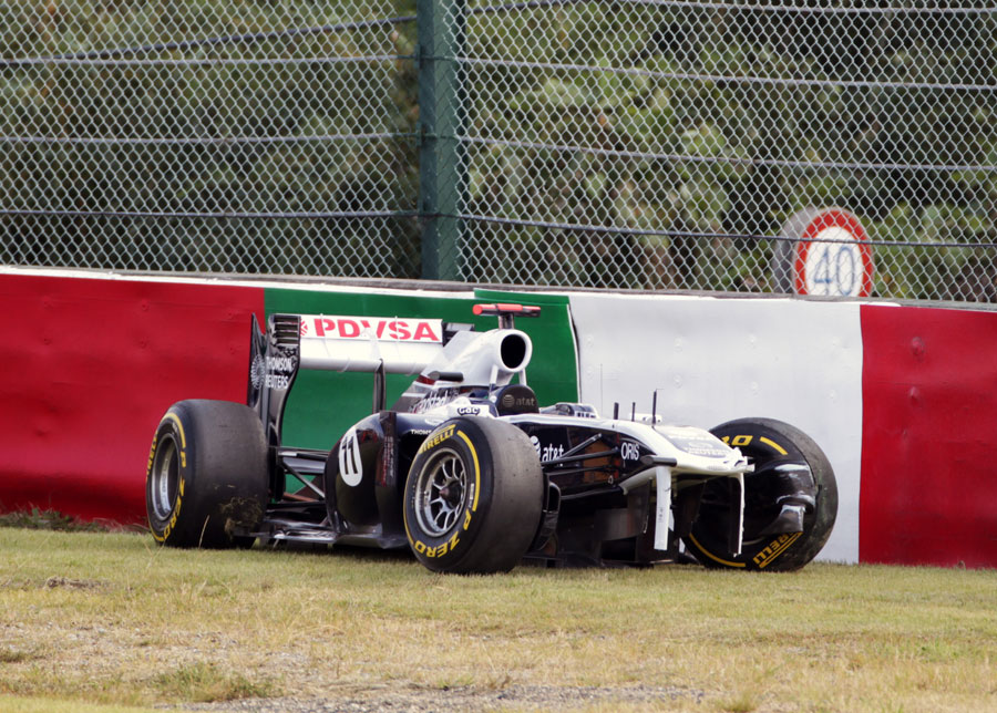 Rubens Barrichello's damaged Williams sits on the outside of the Degner curves after his crash
