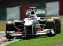 Sergio Perez slides his Sauber onto the artificial grass