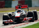 Jenson Button takes an inch-perfect line in his McLaren