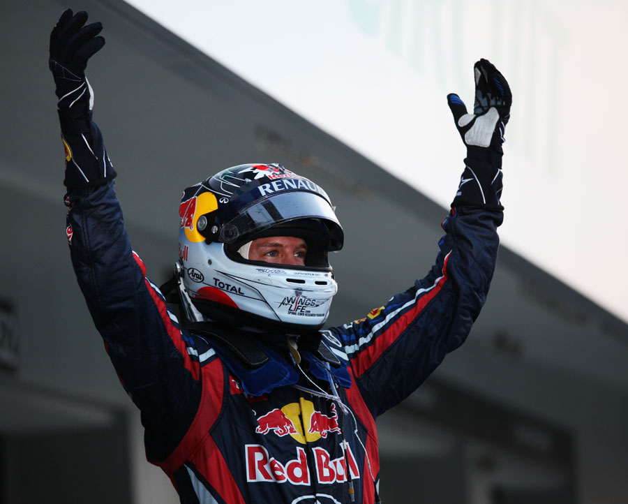 Sebastian Vettel faces the crowd as a newly-crowned double world champion