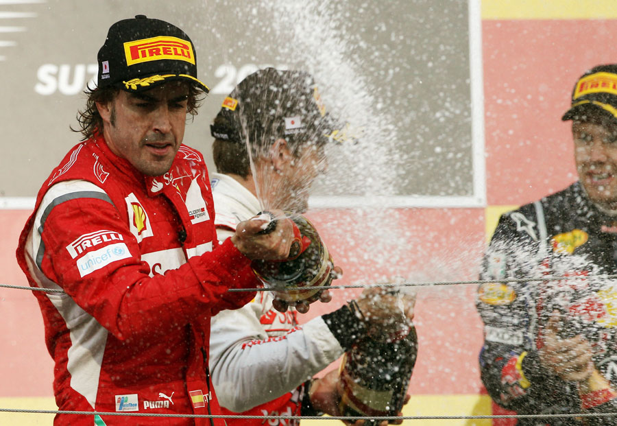 Fernando Alonso celebrates second place on the podium