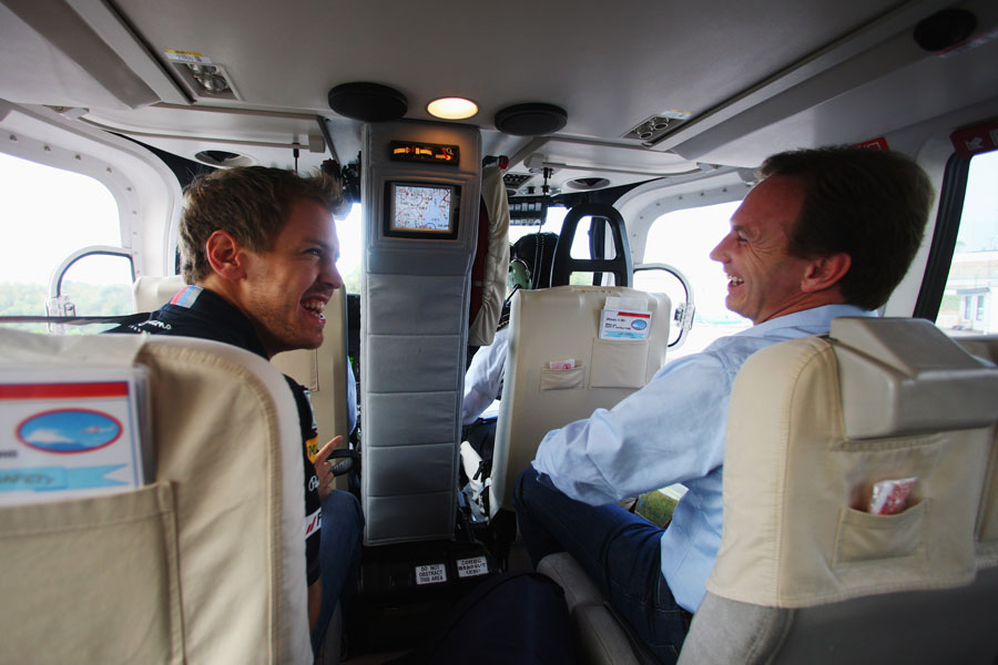 Sebastian Vettel and Christian Horner enjoy a joke on a helicopter ride to Infiniti Design Studios