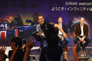 Sebastian Vettel throws his jumper in to the crowd at Nissan HQ after winning his second world championship