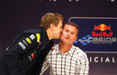 Sebastian Vettel gives David Coulthard a kiss during a Q&A session at Nissan HQ after winning his second world championship