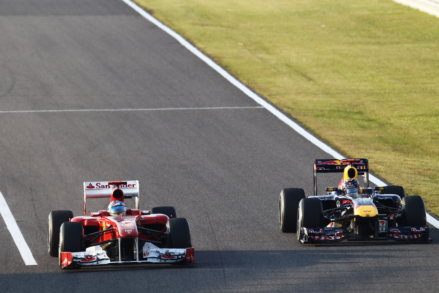 Fernando Alonso holds off Sebastian Vettel in to turn one