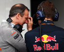 McLaren's Jonathan Neale talks to a memeber of the Red Bull team in the pits