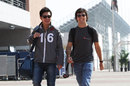 Kamui Kobayashi and Sergio Perez share a joke in the paddock