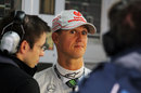 Michael Schumacher tries to look interested