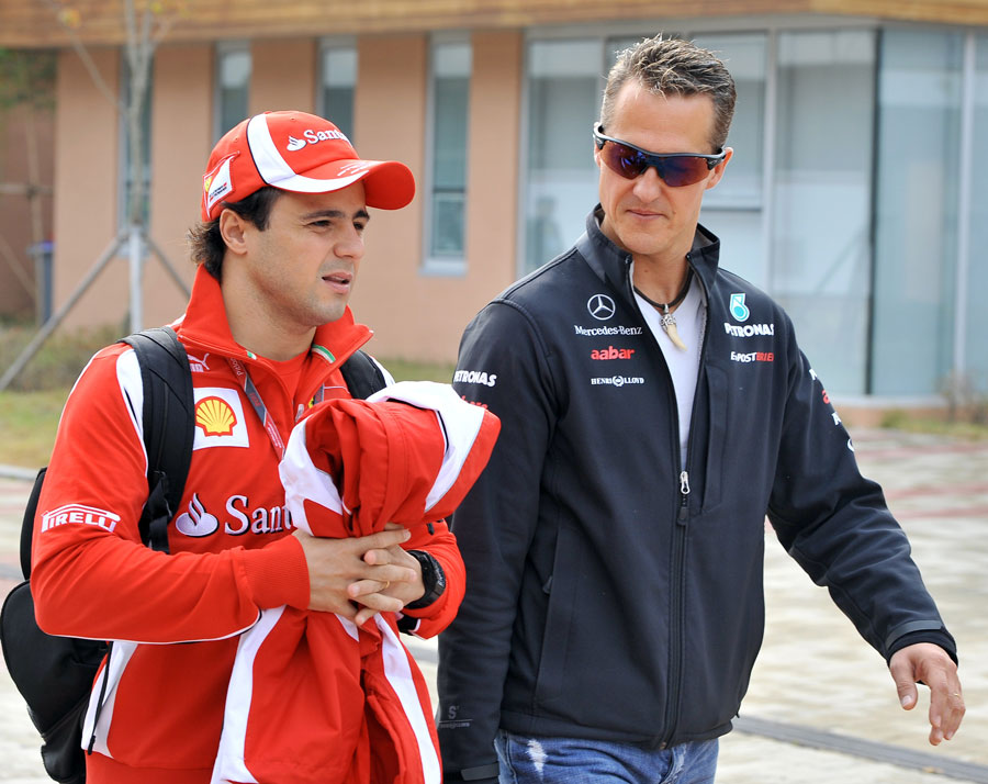 Felipe Massa and Michael Schumacher arrive at the circuit on Saturday morning