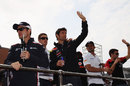 Drivers wave to the crowd on the driver parade