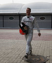Michael Schumacher returns to the paddock after his race came to a premature end