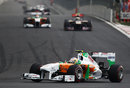Paul di Resta tackles turn three as Sebastien Buemi lines up the other Force India of Adrian Sutil