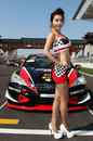 A grid girl before a support race