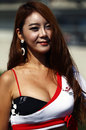 A grid girl before a support race