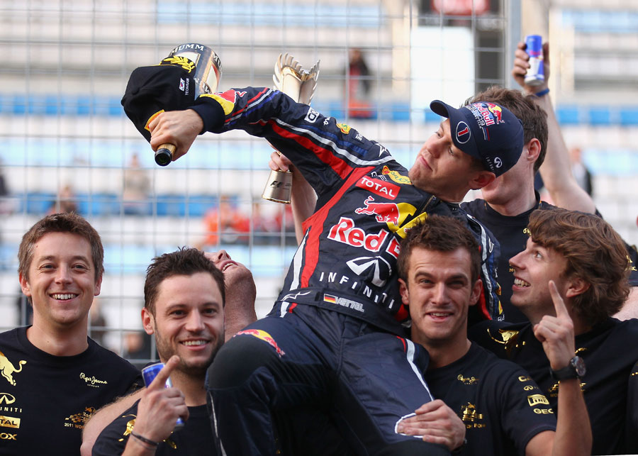 Sebastian Vettel celebrates with his Red Bull mechanics after securing the constructors' championship