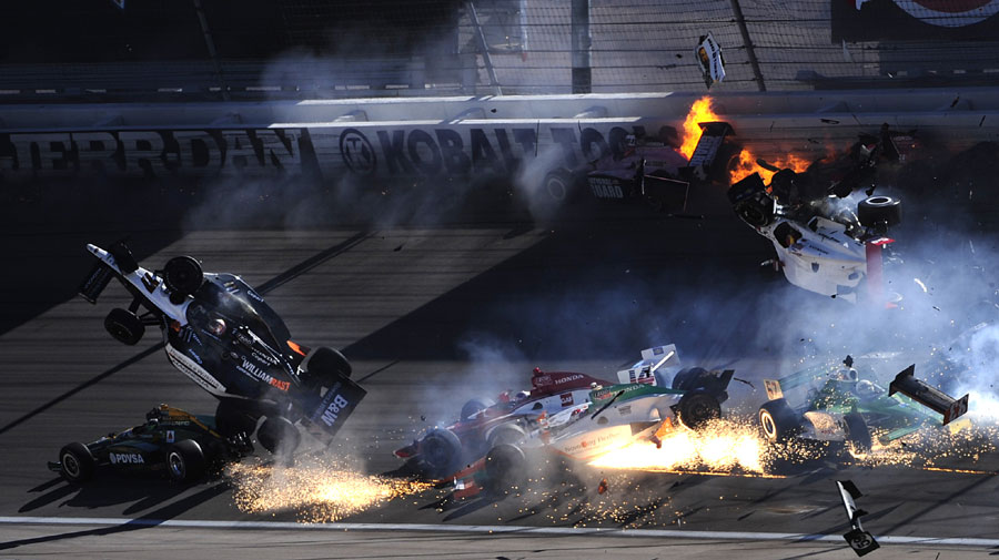 The car of Dan Wheldon (No. 77) flies in the air during a mass pile-up - he was seriously hurt and airlifted to hospital