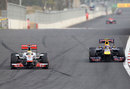 Lewis Hamilton defends from Mark Webber in to turn three