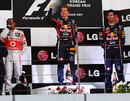 Sebastian Vettel celebrates on the podium alongside Lewis Hamilton and Mark Webber