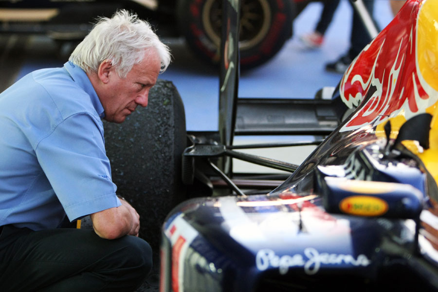 FIA race director Charlie Whiting takes a closer look at the rear of the Red Bull