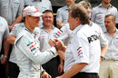 Norbert Haug greets Michael Schumacher ahead of a team photograph