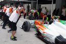 The Force India team practices a pit stop