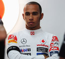 Lewis Hamilton in the back of the McLaren garage wearing an armband in memory of Dan Wheldon